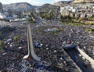 Syrians gather during a celebratory demonstration following the first Friday prayers since Bashar Assad's ouster, in Damascus' central square, Syria, Friday, Dec. 13, 2024. (AP Photo/Ghaith Alsayed)